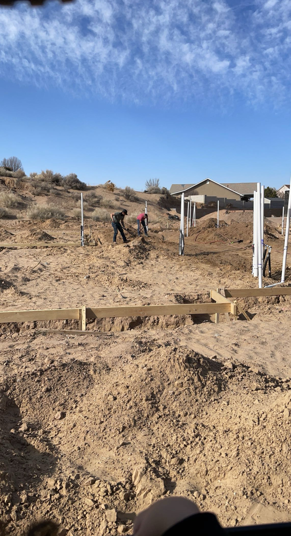 Workers preparing a foundation with wooden framing